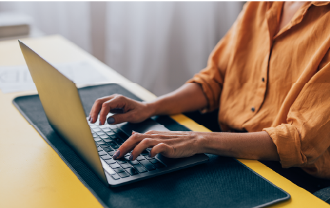 person using a laptop to type