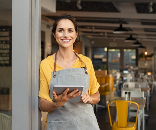 A photo of a woman cooking at the stovetop