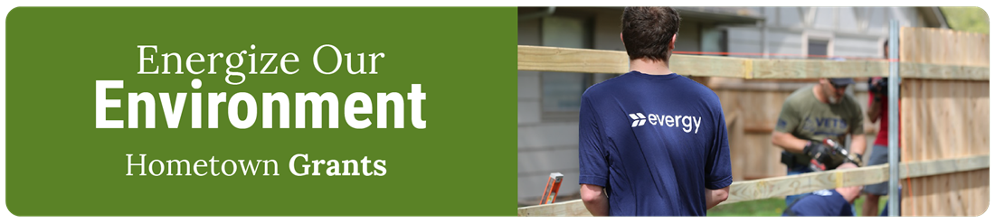 Evergy employees helping to build a fence