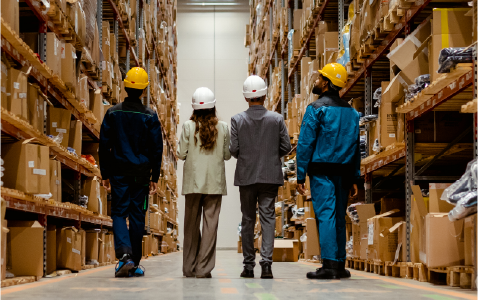 individuals standing in a warehouse