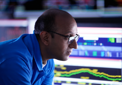 Evergy employee monitors grid status on high-tech equipment