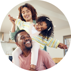 image of a smiling mother, daughter and father playing together
