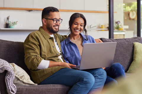 Couple reviewing options on laptop