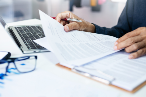 A person reviewing printed documentation