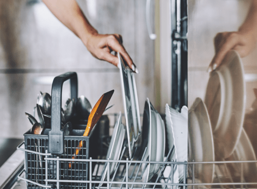 A person doing dishes later at night